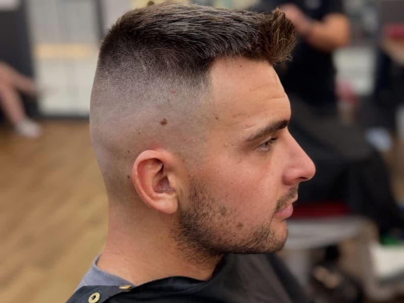 Friendly team at The Grooming Room Barbershop - Kellyville Barbers and customer posing inside The Grooming Room Barbershop in Kellyville