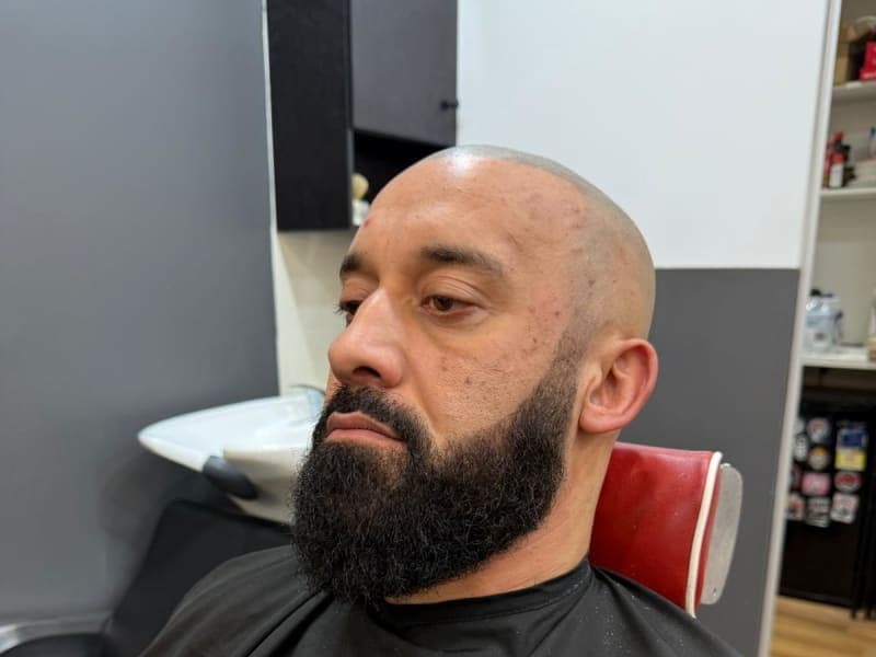 Men's beard service in progress - The Grooming Room Kellyville Professional barber cutting men's hair at The Grooming Room Barbershop in Kellyville