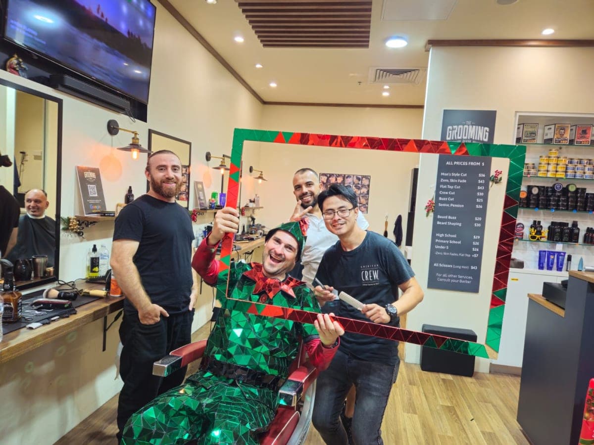 Friendly team at The Grooming Room Barbershop - Kellyville Barbers and customer posing inside The Grooming Room Barbershop in Kellyville