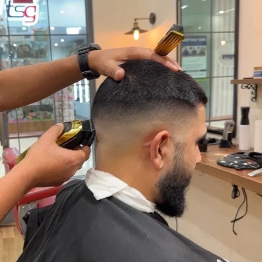 Clean fade haircut service - Kellyville barber Professional barber performing a clean fade haircut at The Grooming Room Barbershop in Kellyville